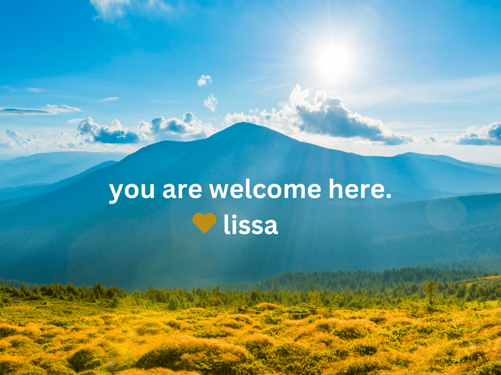 you are welcome here text with mountain landscape, cloudy blue skies, and greenish yellow fields.